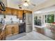 A kitchen features wood cabinetry, stainless steel appliances, and an eat-in area with lots of natural light at 2458 Columbia Dr E # 84, Clearwater, FL 33763