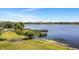 Scenic lake view with a charming wooden dock and lush greenery, ideal for tranquil moments at 2458 Columbia Dr E # 84, Clearwater, FL 33763