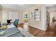 A living room features wood floors with a shag rug, neutral walls, and an open view into the dining room at 2458 Columbia Dr E # 84, Clearwater, FL 33763