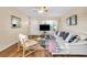 Bright living room featuring hard wood floors, modern furnishings, and ample natural light at 2458 Columbia Dr E # 84, Clearwater, FL 33763