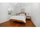Bedroom featuring white walls, hardwood flooring, ceiling fan, and a window with blinds at 246 20Th Ne Ave, St Petersburg, FL 33704