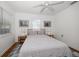 Bright bedroom with a queen bed, ceiling fan, windows and artwork at 246 20Th Ne Ave, St Petersburg, FL 33704