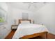 Bright bedroom with hardwood floors, white walls, ceiling fan, and natural light at 246 20Th Ne Ave, St Petersburg, FL 33704
