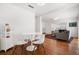 Dining area featuring hardwood floors, white modern table and chairs, and adjacent living room at 246 20Th Ne Ave, St Petersburg, FL 33704