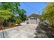Driveway leading to garage with a glimpse of the backyard pool at 246 20Th Ne Ave, St Petersburg, FL 33704