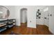 Hallway featuring hardwood floors, a decorative shelf, and open doorways to other rooms at 246 20Th Ne Ave, St Petersburg, FL 33704
