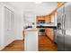 Functional kitchen with stainless appliances, island, wood floors, and a pass-through to the living room at 246 20Th Ne Ave, St Petersburg, FL 33704