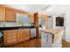 Cozy kitchen with wooden cabinets, stainless steel appliances, black countertops, and hardwood flooring at 246 20Th Ne Ave, St Petersburg, FL 33704