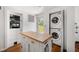Convenient laundry area with stacked washer and dryer and butcher block island for folding at 246 20Th Ne Ave, St Petersburg, FL 33704