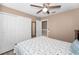 Cozy bedroom with ceiling fan, closet, and light-colored walls at 2574 Hidden Cove Ln, Clearwater, FL 33763