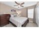 Bright bedroom features a comfortable bed, light walls, and a window for natural light at 2574 Hidden Cove Ln, Clearwater, FL 33763