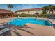 Inviting community pool area with ample seating, shaded pavilion, and mature landscaping at 2574 Hidden Cove Ln, Clearwater, FL 33763