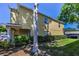 View of exterior with manicured lawn and mature trees at 2574 Hidden Cove Ln, Clearwater, FL 33763
