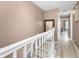 Neutral hallway features white trim, a mirror, and doorways leading to various rooms at 2574 Hidden Cove Ln, Clearwater, FL 33763