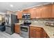Well-equipped kitchen with stainless steel appliances and wooden cabinets at 2574 Hidden Cove Ln, Clearwater, FL 33763