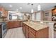 Spacious kitchen with granite countertops, wood cabinets, and modern pendant lighting at 2574 Hidden Cove Ln, Clearwater, FL 33763