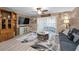 Living room with ceiling fan, painting, and sliding doors to patio at 2574 Hidden Cove Ln, Clearwater, FL 33763