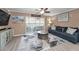Cozy living room with sliding glass doors and ceiling fan at 2574 Hidden Cove Ln, Clearwater, FL 33763