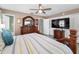 Comfortable main bedroom with wooden accents, featuring neutral decor and closet space at 2574 Hidden Cove Ln, Clearwater, FL 33763