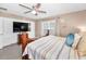 Neutral main bedroom boasts an eye-catching bed, bright windows, and closet space at 2574 Hidden Cove Ln, Clearwater, FL 33763