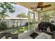 Screened-in patio with outdoor seating and a grill at 2574 Hidden Cove Ln, Clearwater, FL 33763
