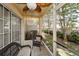 Enclosed patio with wicker seating and backyard view at 2574 Hidden Cove Ln, Clearwater, FL 33763