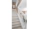 Bright staircase features white railing and neutral walls, offering a grand entrance at 2574 Hidden Cove Ln, Clearwater, FL 33763