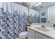Bathroom featuring a vanity with sink and a shower with a floral curtain at 2663 Sequoia Ter # 2663, Palm Harbor, FL 34683