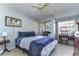 Cozy bedroom with a comfortable bed, a ceiling fan, and a window providing natural light at 2663 Sequoia Ter # 2663, Palm Harbor, FL 34683