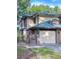 Charming townhome with an attached garage, brick accents, and mature landscaping at 2663 Sequoia Ter # 2663, Palm Harbor, FL 34683