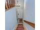 View down the stairs to the front door and tiled foyer with rug at 2663 Sequoia Ter # 2663, Palm Harbor, FL 34683