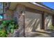 Attached garage and brick detailing with manicured landscaping and exterior lighting at 2663 Sequoia Ter # 2663, Palm Harbor, FL 34683