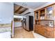 Bright kitchen features white cabinets, stainless steel appliances, and wood-look floors at 2663 Sequoia Ter # 2663, Palm Harbor, FL 34683