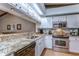 Gourmet kitchen featuring stainless steel appliances and granite countertops at 2663 Sequoia Ter # 2663, Palm Harbor, FL 34683
