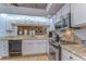 Well-lit kitchen with stone countertops and stainless steel appliances at 2663 Sequoia Ter # 2663, Palm Harbor, FL 34683