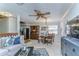 Bright, open-concept living area featuring a dining table, china cabinet, and view of the kitchen at 2663 Sequoia Ter # 2663, Palm Harbor, FL 34683