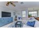Upstairs living area showcasing comfortable seating, a TV unit, and views into the dining and kitchen areas at 2663 Sequoia Ter # 2663, Palm Harbor, FL 34683