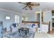 A bright, open living area with a sectional sofa, decorative rug, and an adjoining dining area at 2663 Sequoia Ter # 2663, Palm Harbor, FL 34683