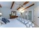 Bright main bedroom features wooden beams, ceiling fan, and glass doors to the patio at 2663 Sequoia Ter # 2663, Palm Harbor, FL 34683