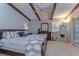 Bright main bedroom featuring wooden beams, ceiling fan, and a comfortable king-size bed at 2663 Sequoia Ter # 2663, Palm Harbor, FL 34683