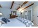 Bright main bedroom features wooden beams, ceiling fan, and glass doors to the patio at 2663 Sequoia Ter # 2663, Palm Harbor, FL 34683