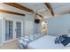 Bright main bedroom features wooden beams, a ceiling fan, and an en-suite bathroom at 2663 Sequoia Ter # 2663, Palm Harbor, FL 34683