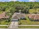 Aerial shot of the home showcasing the manicured yard, nearby trees, and neighborhood surroundings at 28628 Twinbrook # Ln, Wesley Chapel, FL 33543