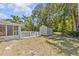 Large backyard with mature trees and a storage shed, providing ample space for outdoor enjoyment at 28628 Twinbrook # Ln, Wesley Chapel, FL 33543