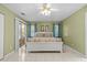 Spacious bedroom with large bed, ceiling fan, and sliding glass door to the outdoor patio at 28628 Twinbrook # Ln, Wesley Chapel, FL 33543