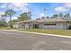 Well-maintained community building with ample parking and beautiful landscaping on a sunny day at 28628 Twinbrook # Ln, Wesley Chapel, FL 33543