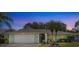 Charming home exterior featuring a two-car garage, landscaped front yard, and inviting curb appeal at 28628 Twinbrook # Ln, Wesley Chapel, FL 33543