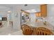 Open concept kitchen featuring a breakfast bar, stainless steel appliances and adjacent fireplace at 28628 Twinbrook # Ln, Wesley Chapel, FL 33543