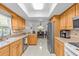 Bright kitchen features stainless steel appliances, light wood cabinetry, and an eat-in dining area at 28628 Twinbrook # Ln, Wesley Chapel, FL 33543