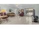 Open living room with tile floors, comfortable seating, and sliding glass doors to the lanai at 28628 Twinbrook # Ln, Wesley Chapel, FL 33543